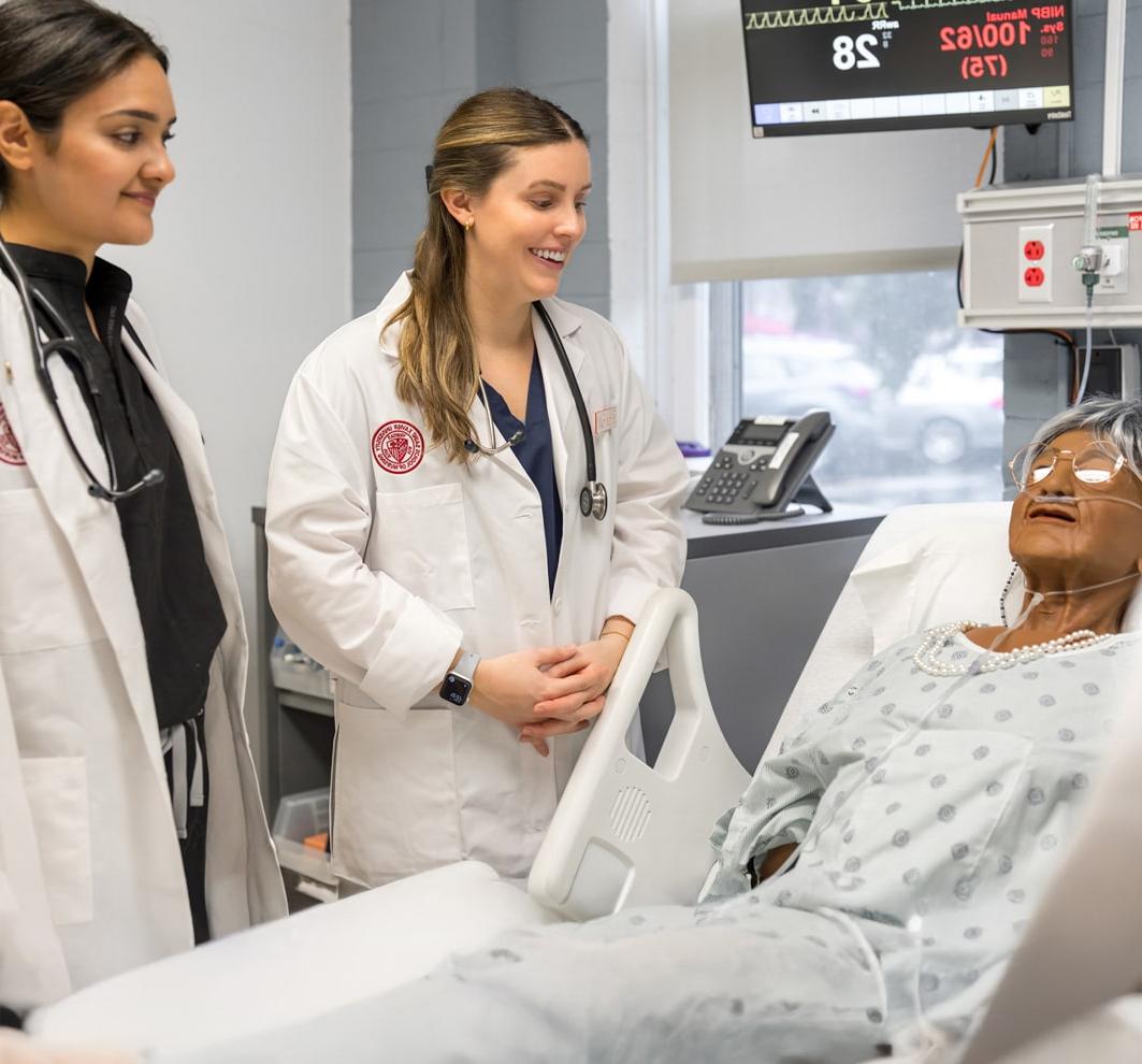 Nursing students working on a model patient